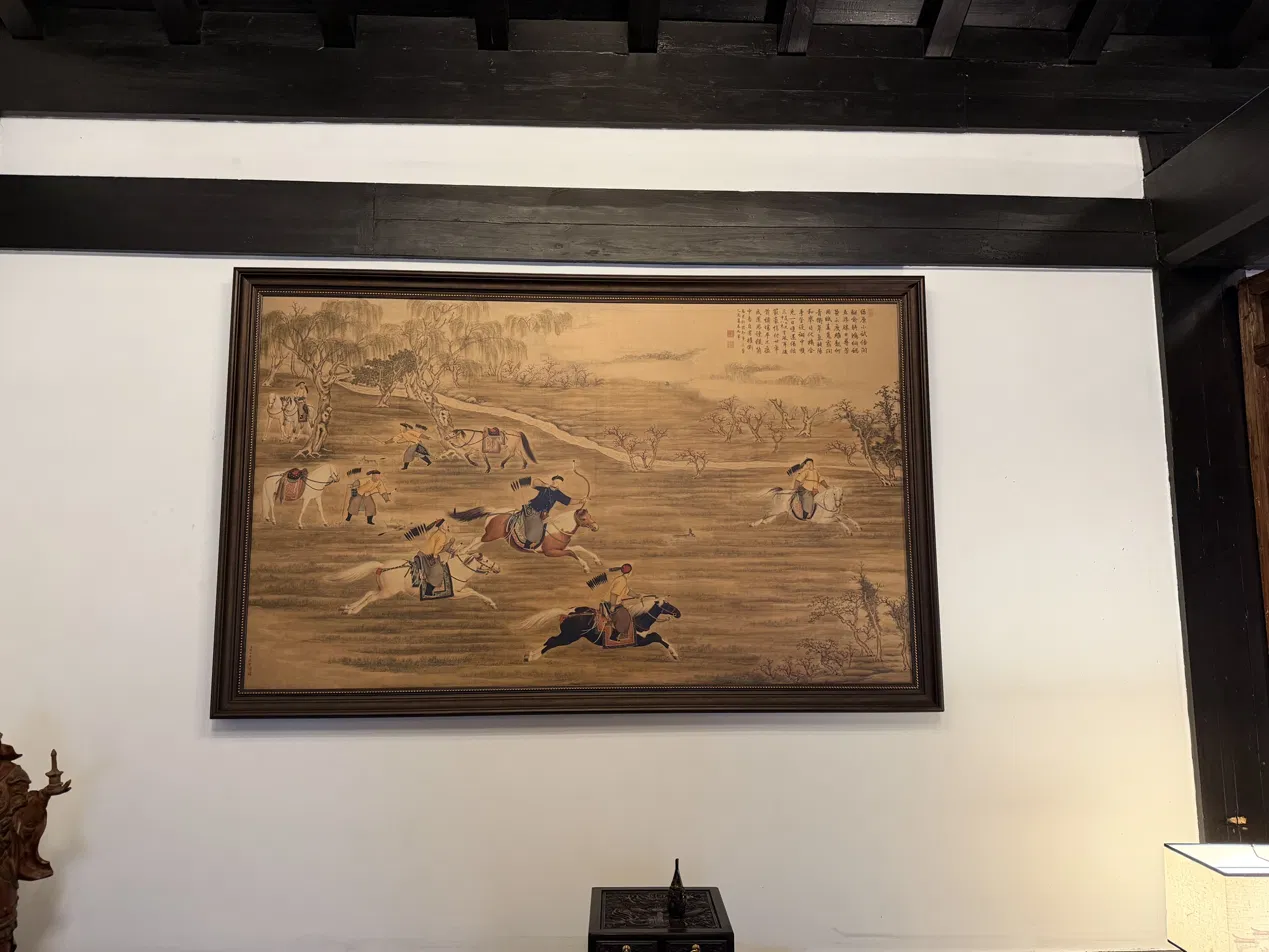 Framed artwork depicting several mounted archers