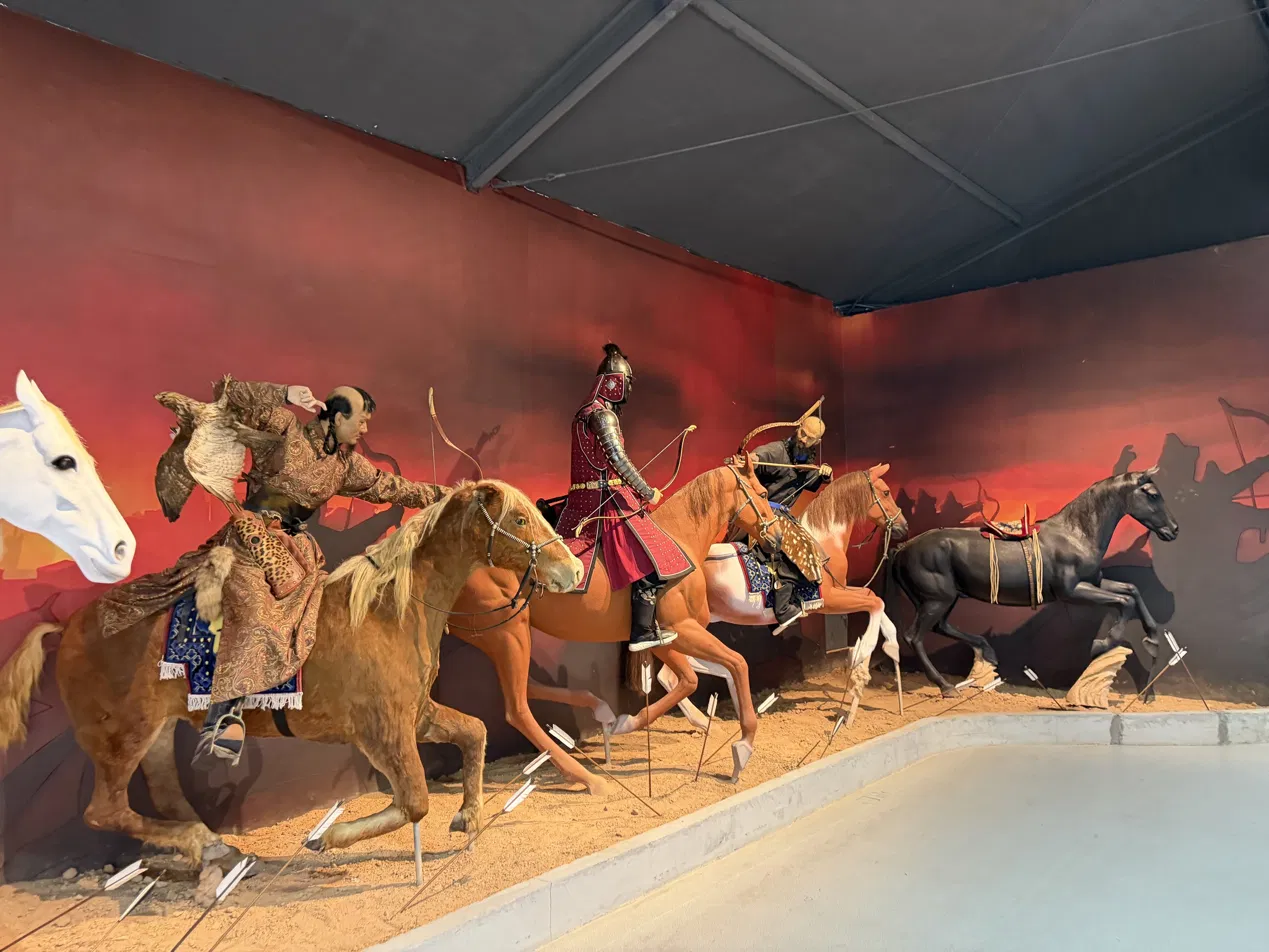 Exhibition figures of mounted archers carrying traditional bows