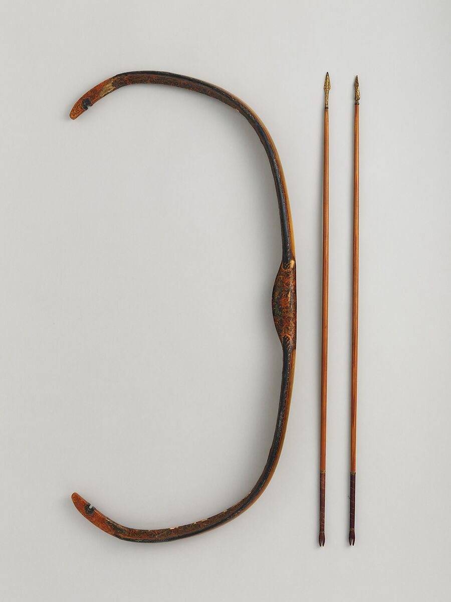A Turkish traditional bow displayed beside two arrows